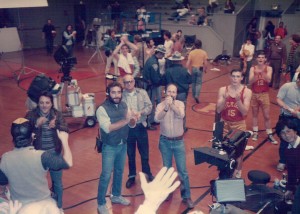The cast and crew applaud the extras in the bleachers.
